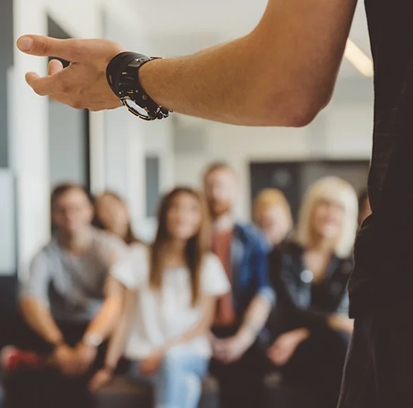 A group treatment session with participants listening to a facilitator